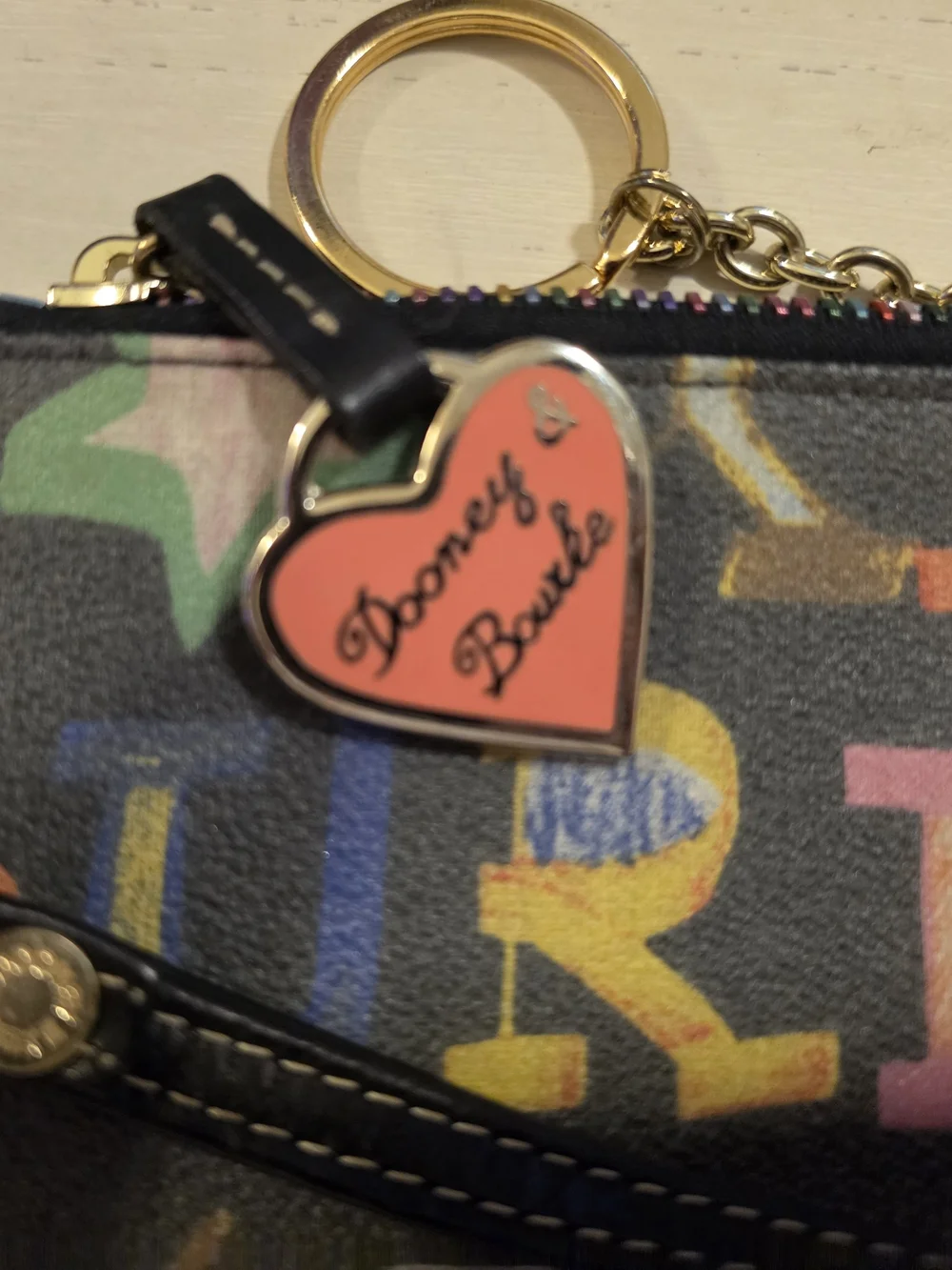 Dooney & Bourke Vintage multicolor letter/graffiti print coated Wristlet